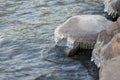 Icicles on stone on the beach in sunny winter day Royalty Free Stock Photo