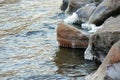 Icicles on stone on the beach in sunny winter day Royalty Free Stock Photo