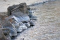 Icicles on stone on the beach in sunny winter day Royalty Free Stock Photo