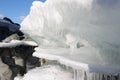 Icicles on stones at the thawing river