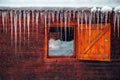 Icicles. View from a cottage window in heavy winter in the mountains Royalty Free Stock Photo