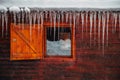 Icicles. View from a cottage window in heavy winter in the mountains Royalty Free Stock Photo