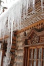 Icicles in winter. Icicles on a wooden hut. Wooden house in ice. Ice covers the log walls and icicles hang from the roof Royalty Free Stock Photo