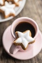 Icing gingerbread stars. Traditional Christmas cookies and coffee cup Royalty Free Stock Photo