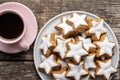 Icing gingerbread stars. Traditional Christmas cookies and coffee cup Royalty Free Stock Photo