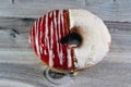 Icing powdered confectioners' sugar and Strawberry flavored ring donut, A glazed, yeast raised, American style ring doughnut Royalty Free Stock Photo
