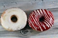 Icing powdered confectioners' sugar and Strawberry flavored ring donut, A glazed, yeast raised, American style ring doughnut