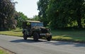 Vintage WWII-period 1944 Willys jeep on country road.