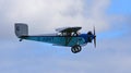 Vintage 1931 Civilian Coupe 02 G-ABNT aircraft in flight with blue sky and clouds.