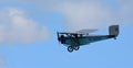 Vintage 1931 Civilian Coupe 02 G-ABNT aircraft in flight with blue sky and clouds.