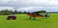 Vintage 1931 Desoutter 1 High Wing aircraft being towed by vintage tractor.