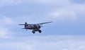 1938 Westland Lysander aircraft in flight blue sky and clouds.