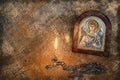 Icon of the Archangel Michael with silver and gilding, a pectoral cross and a burning candle Royalty Free Stock Photo