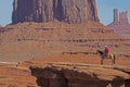 A native American walks his horse in Monument Valley. Royalty Free Stock Photo