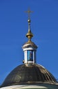 Icon on the roof of the church. Dome of the roof against the blue sky.