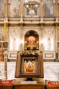 Icon on a stand stands on the table in front of the altar in the Church of St. Sava in Tivat