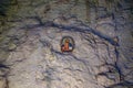 Icon on the stone wall inside cave 1