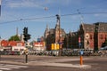 Iconic Amsterdam Centraal building undergoing construction, with large cranes and workers visible against a bright blue Royalty Free Stock Photo