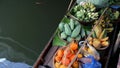 Iconic asian Lat Mayom floating market. Khlong river canal, long-tail boat with tropical exotic colorful fruits, organic locally Royalty Free Stock Photo