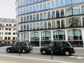 Iconic black cabs or taxi in traffic in London Cannon street , England