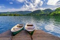 Iconic Bled scenery. Boats at lake Bled, Slovenia, Europe. Wooden boats with Pilgrimage Church of the Assumption of Maria on Royalty Free Stock Photo
