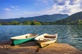 Iconic Bled scenery. Traditional wooden boats Pletna at lake Bled, Slovenia, Europe. Wooden boats with Pilgrimage Church of the Royalty Free Stock Photo