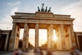 The iconic Brandenburg Gate in Berlin against the backdrop of a soft sunset sky