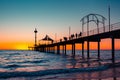 Iconic Brighton jetty with people silhouettes at sunset Royalty Free Stock Photo