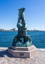 Iconic bronze sculpture of polar bear and two young on waterfront near the Little Mermaid Statue in Copenhagen, Denmark