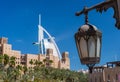 Iconic Burj hotel behind arabic buildings in Souk Madinat Jumeirah in Dubai Royalty Free Stock Photo