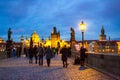 Iconic Charles Bridge people sightseeing at twilight Orague city Czechia Royalty Free Stock Photo