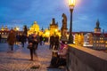 Iconic Charles Bridge people sightseeing at twilight Prague city Czechia Royalty Free Stock Photo