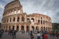 Iconic Colosseum in Rome with tourists and cloudy sky in ancient splendor Royalty Free Stock Photo