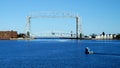 Iconic Duluth Minnesota aerial lift bridge with small boat ferrying portable toilets across the harbor