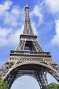 Iconic Eiffel Tower against a blue sky with clouds, Paris, France