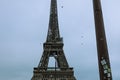 Iconic Eiffel Tower against a cloudy sky, creating an impressive contrast of light and dark Royalty Free Stock Photo
