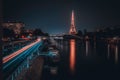 Of the iconic Eiffel Tower in a tranquil body of water at night time