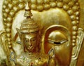 Iconic gold religious heads, with enigmatic expressions, in juxtaposition