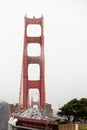 Iconic Golden Gate Bridge in San Francisco, California with cars driving along it covered by fog