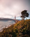 Iconic Golden Gate Bridge in San Francisco, California, shrouded in a cloudy morning sky at sunrise