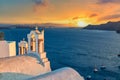 Iconic Greek picture. Beautiful sunset with famous Orthodox church on Santorini island, Aegean sea, Greece Royalty Free Stock Photo