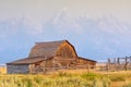 Wyoming Moulton Barn with Tetons and summer grass and smokey haze Royalty Free Stock Photo