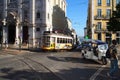 Iconic No. 28 Tram car and tuk-tuk auto-rickshaw in Chiado, Lisbon, Portugal Royalty Free Stock Photo