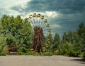 Iconic pripyat ferris wheel seen from the open area in front of it. No people around. Dramatic cloudy day during the summer in the Royalty Free Stock Photo