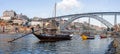 The iconic Rabelo Boats, the traditional Port Wine transports, with the Ribeira District and the Dom Luis I Bridge Royalty Free Stock Photo