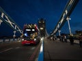 Iconic red double-decker bus on illuminated famous Tower Bridge Thames river in London England UK Great Britain at night Royalty Free Stock Photo