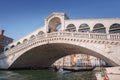 Iconic Rialto Bridge spanning the Grand Canal in Venice, Italy amidst bustling cityscape. Royalty Free Stock Photo