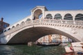 Iconic Rialto Bridge spanning the Grand Canal in Venice, Italy amidst bustling cityscape. Royalty Free Stock Photo