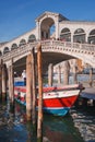 Iconic Rialto Bridge spanning the Grand Canal in Venice, Italy amidst bustling cityscape. Royalty Free Stock Photo