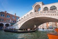 Iconic Rialto Bridge spanning the Grand Canal in Venice, Italy amidst bustling cityscape. Royalty Free Stock Photo